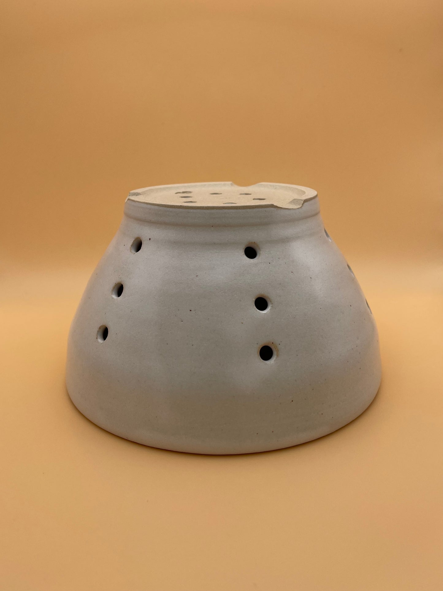 Base view of handmade white ceramic berry bowl showing glaze detail and foot ring