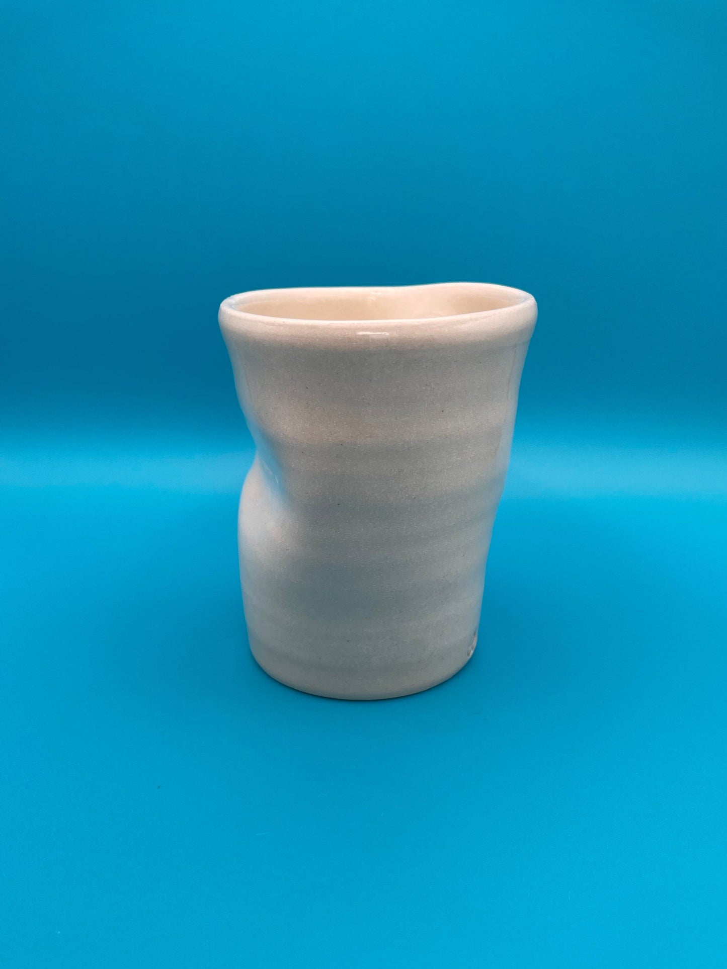 Non Paper Cup Crush – hand-thrown ceramic coffee cup with a crushed shape, made from stoneware clay and glazed with a transparent glaze