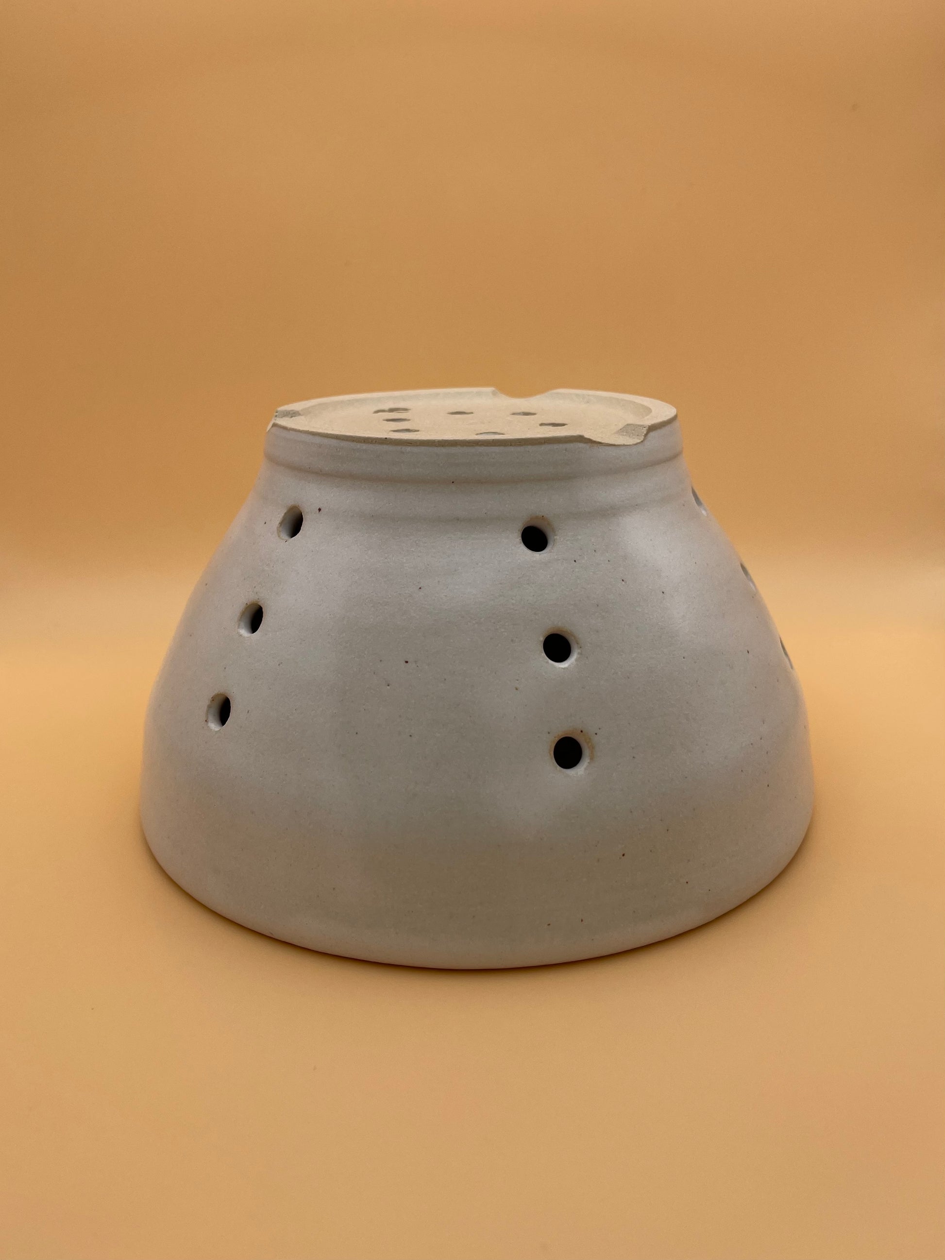 Base view of handmade white ceramic berry bowl showing glaze detail and foot ring