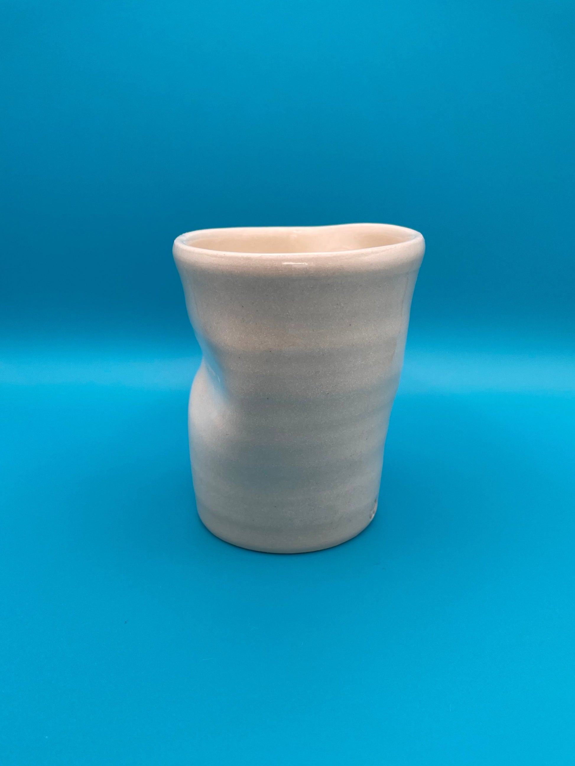 Non Paper Cup Crush – hand-thrown ceramic coffee cup with a crushed shape, made from stoneware clay and glazed with a transparent glaze